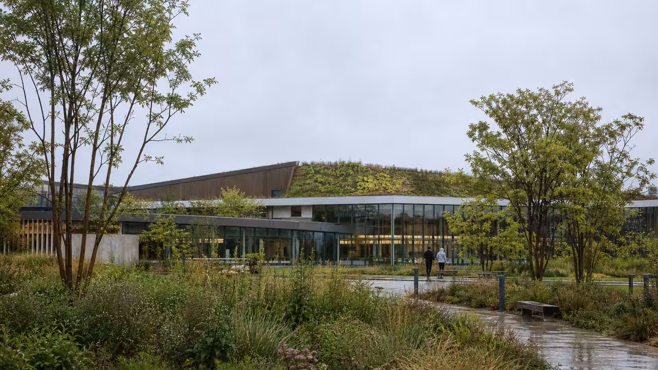 Abords végétalisés d’un centre aquatique avec noue paysagère et cheminement public perméable