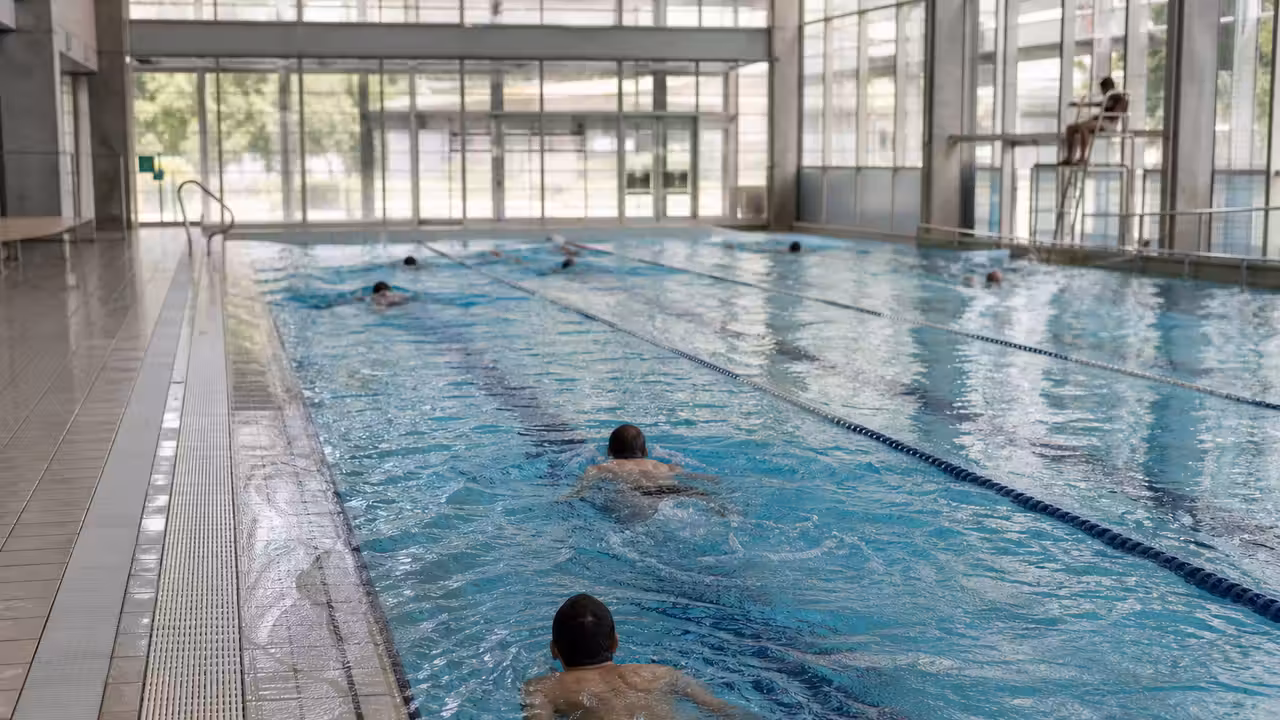 Nageurs dans un bassin municipal de 25 mètres sous la surveillance d’un maître-nageur à Gaillac