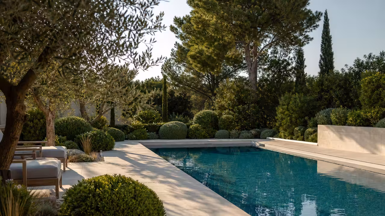 Bassin contemporain entouré de plantations basses et d’une terrasse minérale dégagée des végétaux