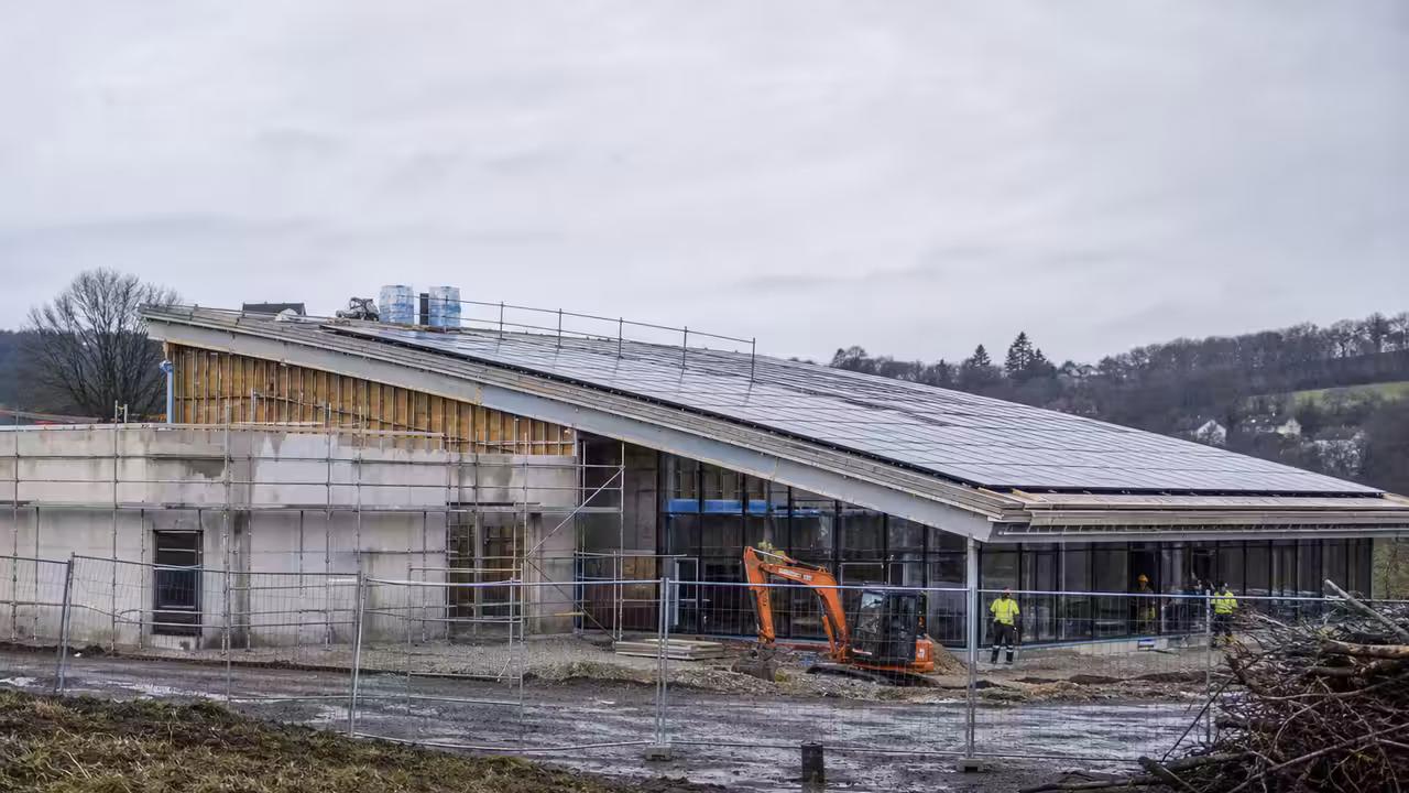 Chantier d'un centre aquatique public avec toiture équipée de panneaux photovoltaïques